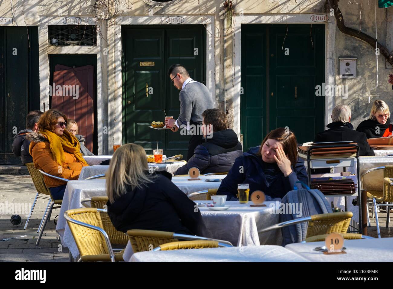People sitting outside restaurant on Campo San Polo in Venice, Italy Stock Photo