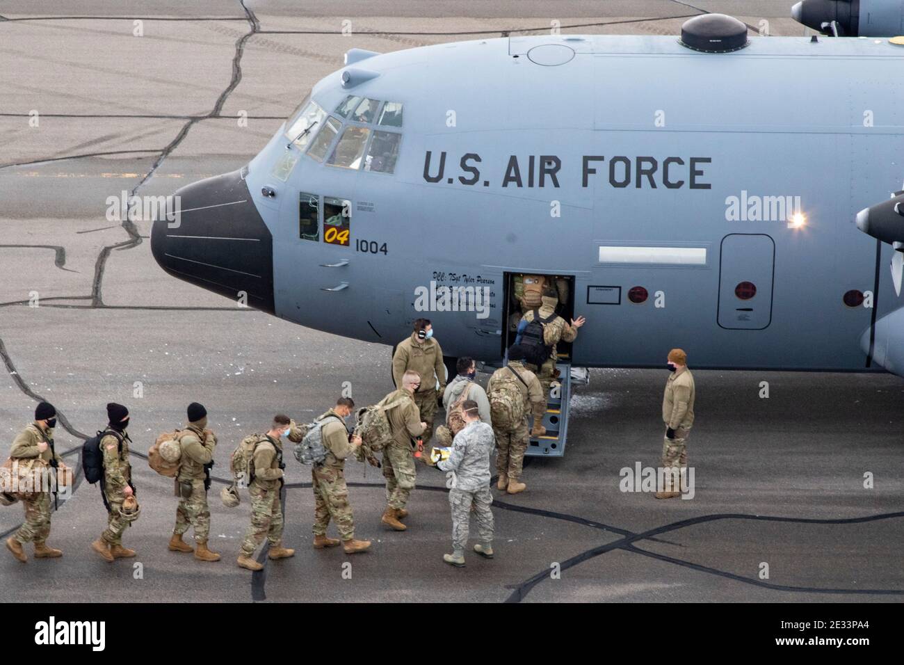 Little Falls, United States. 16th Jan, 2021. U.S. soldiers with the Minnesota Army National Guard board a C-17 Globemaster III transport aircraft as as they head for the Inauguration January 15, 2021 in Little Falls, Minnesota. More than 20,000 national guard troops have been deployed to provide security following the insurrection by Pro-Trump rioters. Credit: Planetpix/Alamy Live News Stock Photo