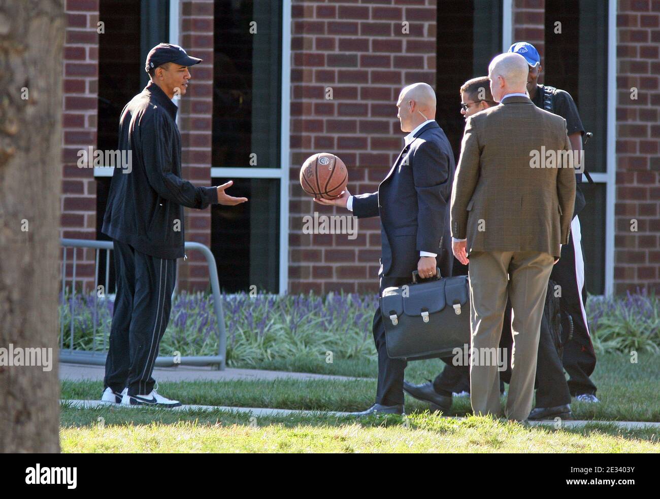 President Barack Obama is handed a basketball by a military aide as he arrives at Fort Leslie J. McNair's athletic facility for a morning game of basketball in Washington, DC, USA on September 18, 2010. Also shown are Reggie Love, the president's personal aide (blue cap), and other unidentified aides. Photo by Martin H. Simon/ABACAPRESS.COM (Pictured: Barack Obama, Reggie Love) Stock Photo