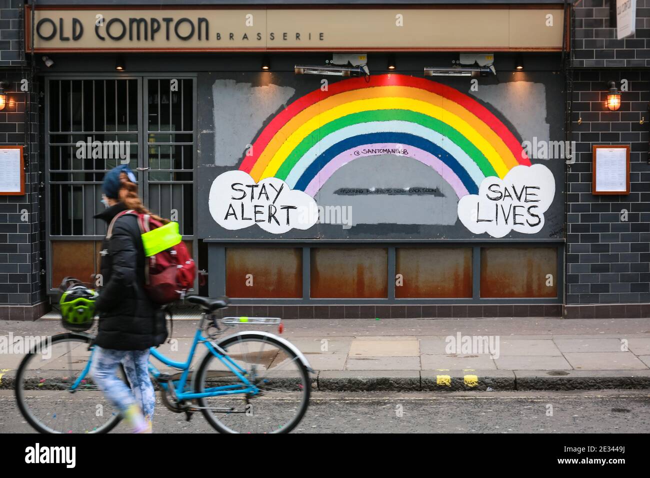 London, UK. 15 Jan 2021. A woman walking past the Stay Alert Save Lives Rainbow Sign in Soho. Credit: Waldemar Sikora Stock Photo