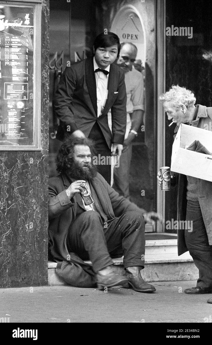 Two tramps being moved on from restaurant steps by staff, Soho, London, UK in 1977 Stock Photo