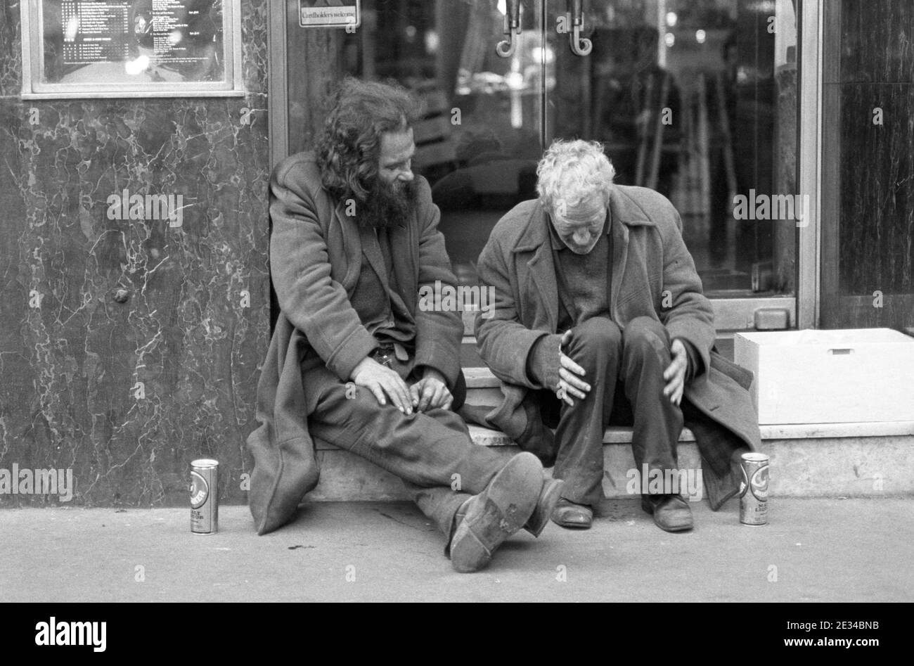 Two tramps chatting on restaurant steps, Soho, London, UK in 1977 Stock Photo