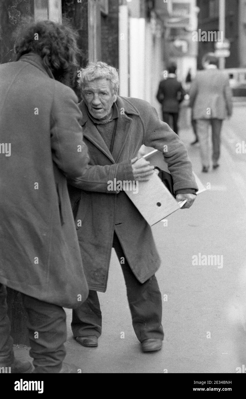Two tramps chatting in a Soho street, London, UK in 1977 Stock Photo