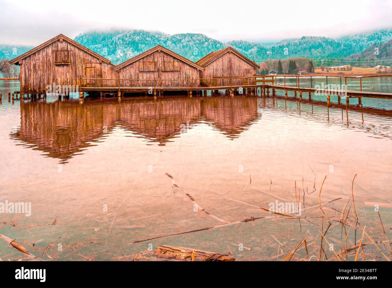 Fantastic shot of three wooden houses on the water with a pier Stock ...
