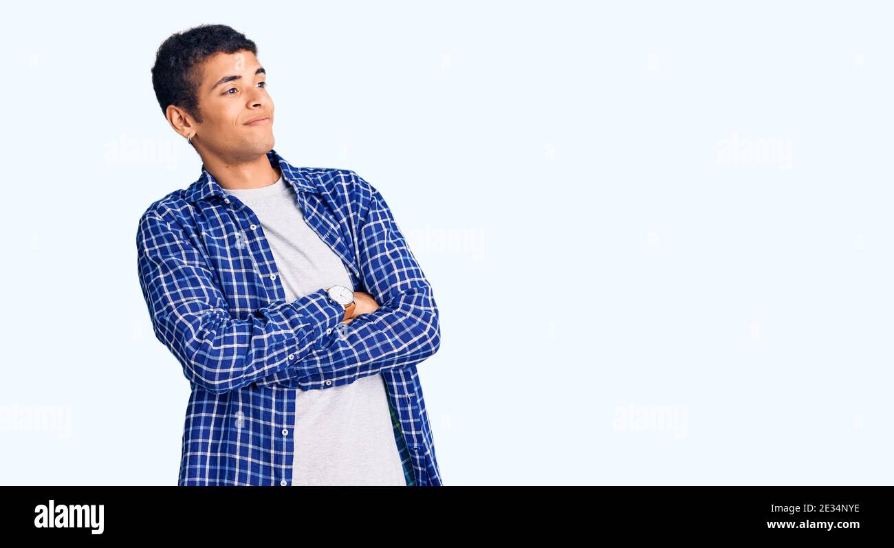 Young african amercian man wearing casual clothes looking to the side with arms crossed convinced and confident Stock Photo