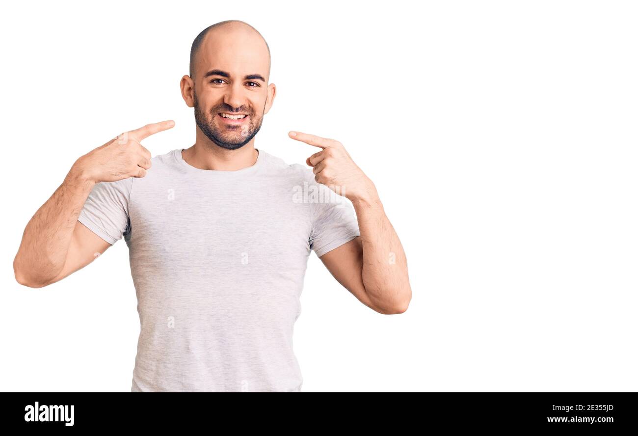 Young handsome man wearing casual t shirt smiling cheerful showing and ...