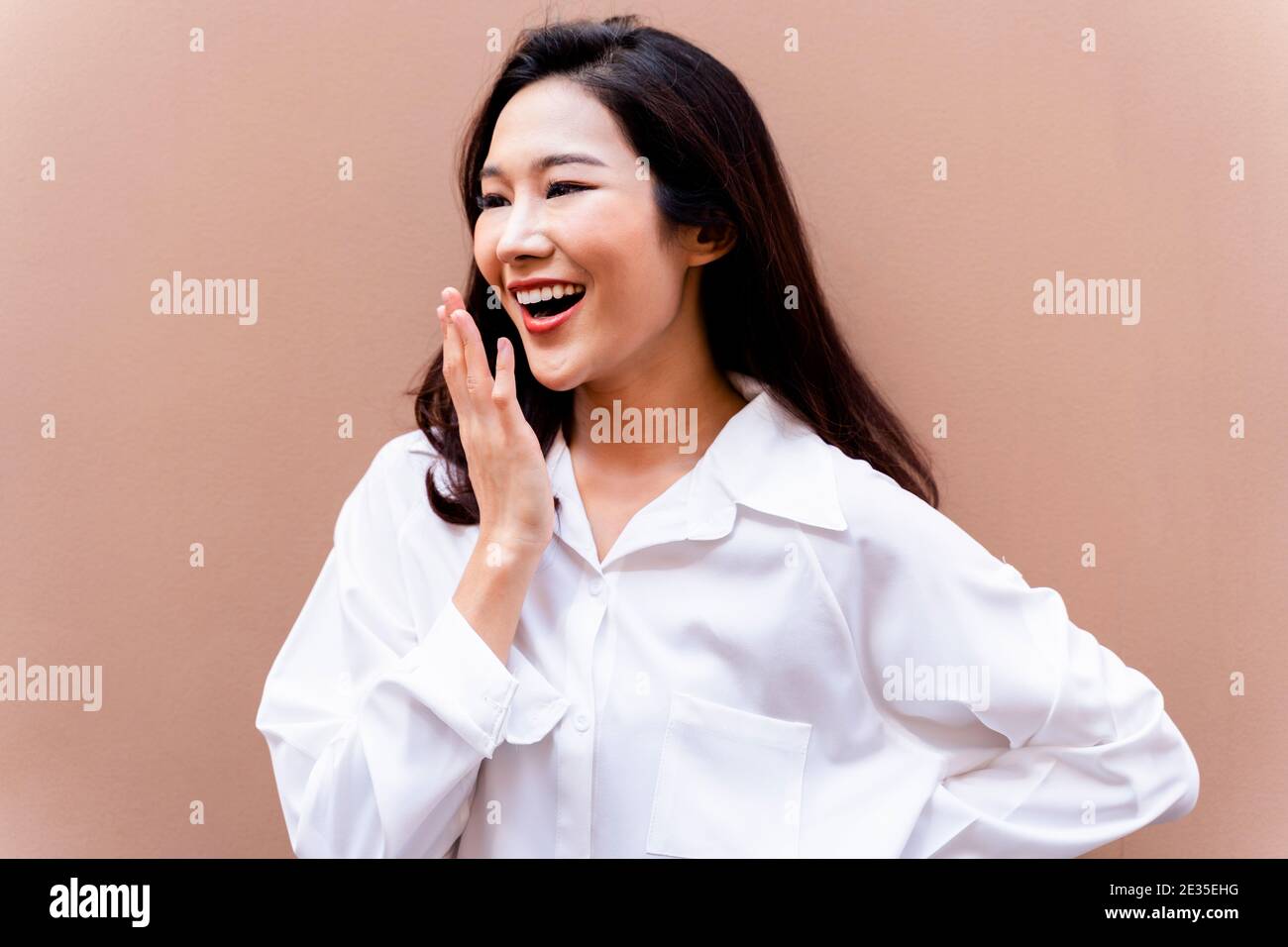 20s young Asian happy millennial woman in white shirt in clean background smiling  Stock Photo