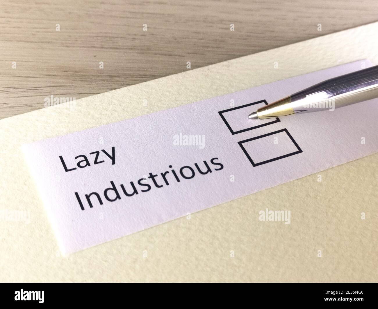 One person is answering question on a piece of paper. The person is thinking to be lazy or to be industrious. Stock Photo