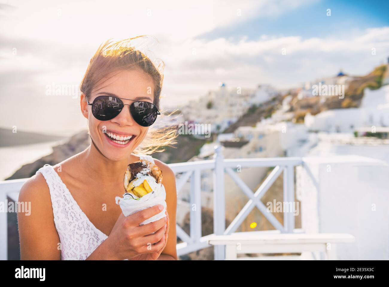 Greek food gyro pita tourist woman eating local typical sandwich on Greece vacation travel. Stock Photo