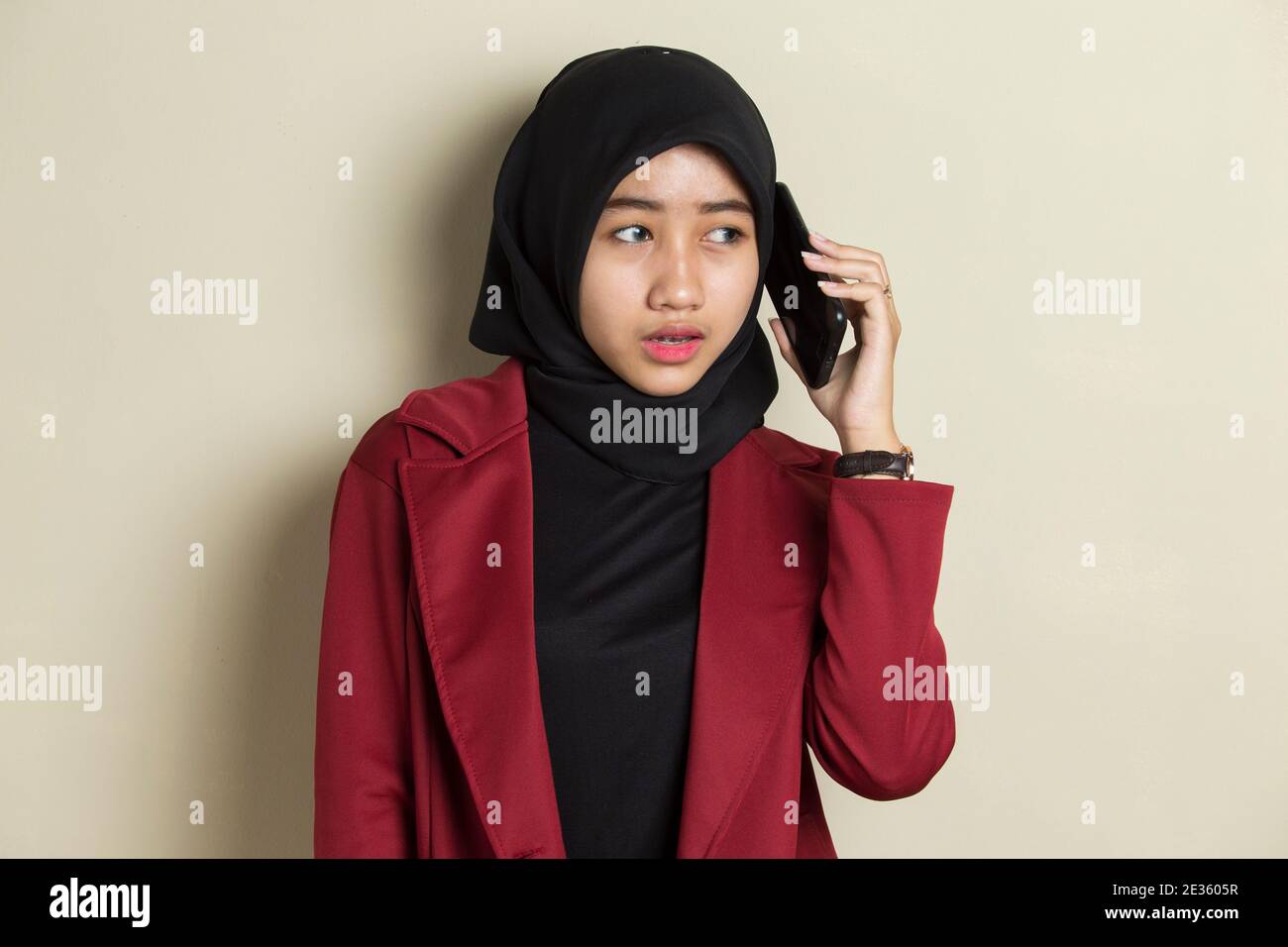 Portrait of a young asian muslim woman using mobile phone Stock Photo ...