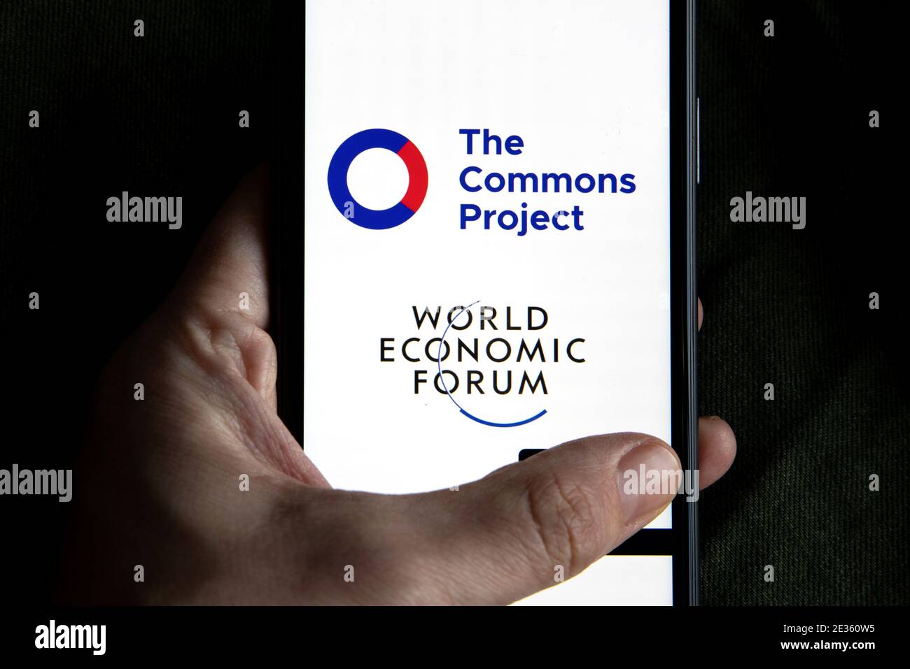 Vaccine passport app company logo displayed on a smartphone next to world economic forum logo. The Commons pass Project. Travel again. Stock Photo