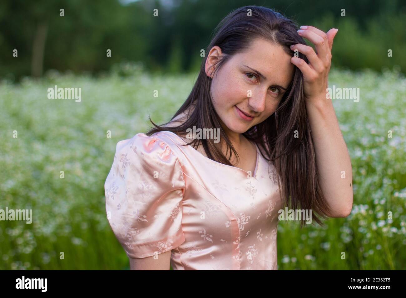 girl standing in the field in a pink dress Stock Photo - Alamy