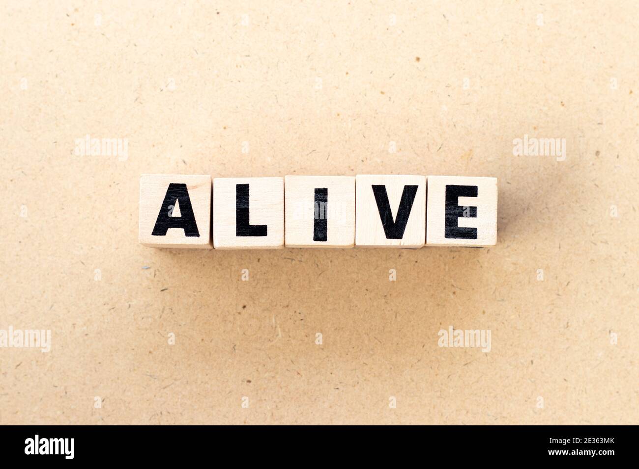 Letter block in word alive on wood background Stock Photo - Alamy