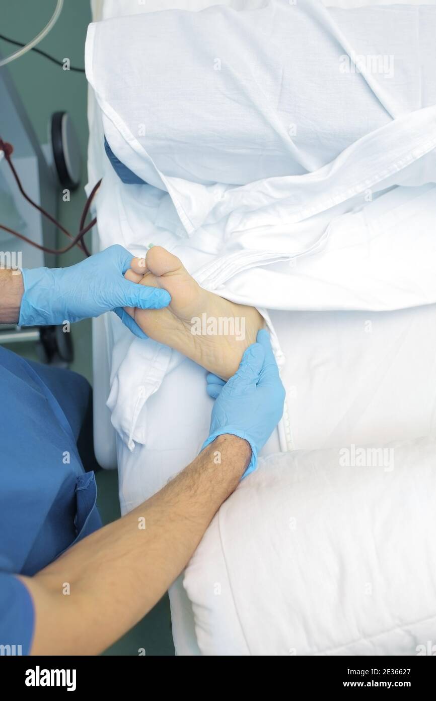 Doctor examines the patient's foot. Stock Photo