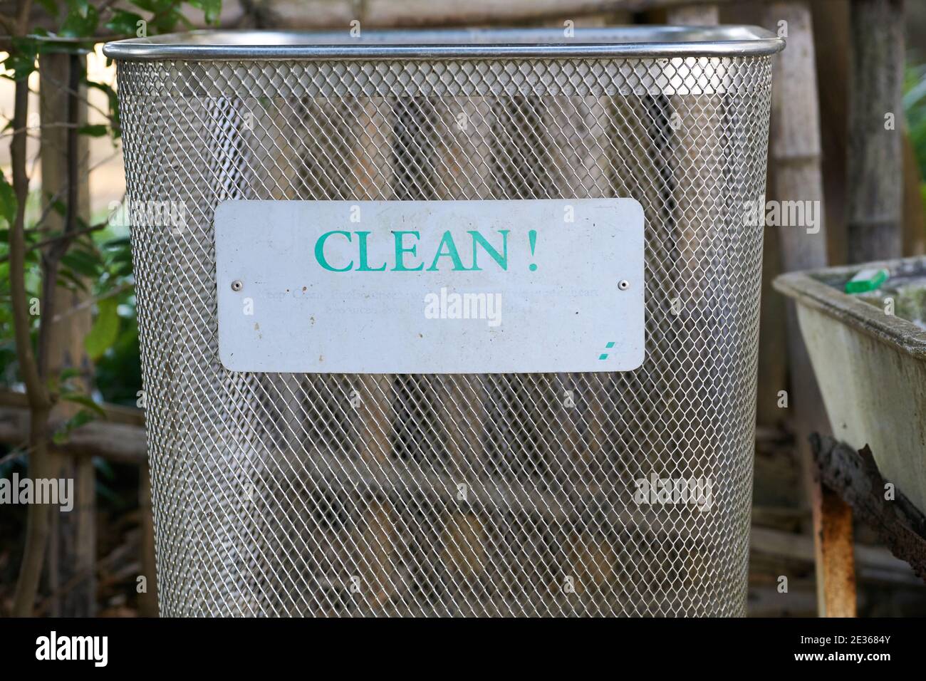 Outdoor metal rubbish bin in Japan with faded sign that now only says 'Clean!' Stock Photo
