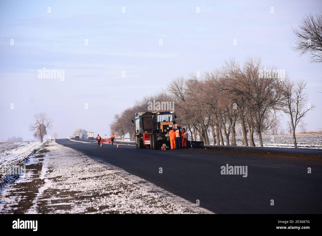 road workers repair the road. Municipal service repairs the road. Stock Photo