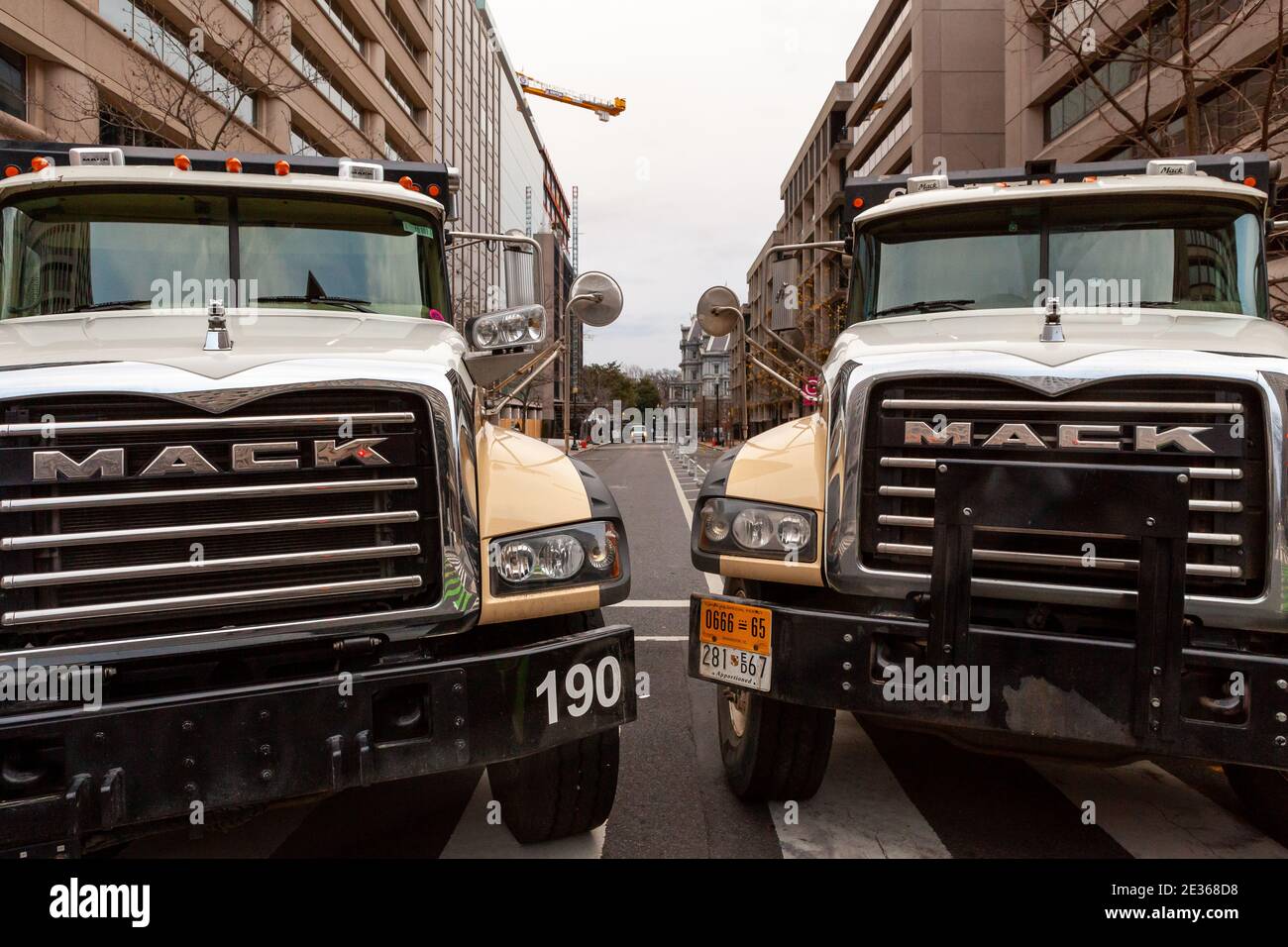 Washington, DC, USA 16 January, 2021.  Pictured: Two enormous Mack trucks block F Street NW in preparation for the presidential inauguration of Joe Biden.  Preparations and security measures were instituted far earlier than usual due to the threat of violence posed by Trump supporters, white supremacists, and other right-wing exremists.  Credit: Allison C Bailey/Alamy Live News Stock Photo