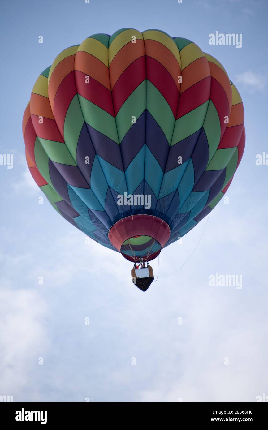Multicolored hot air balloon in blue cloudy sky. Beautiful Hot Air ...