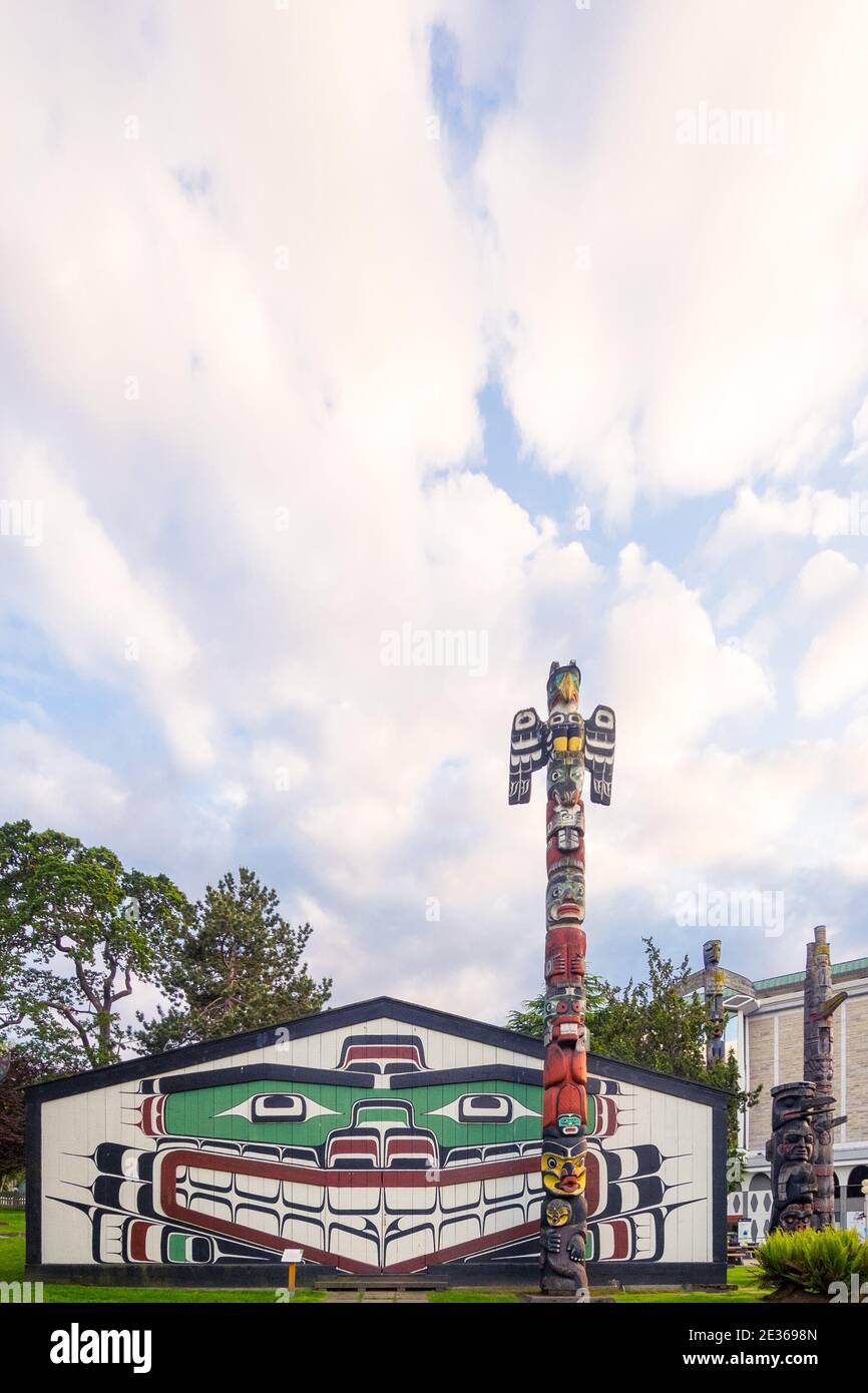 Kwakwaka’wakw Heraldic Pole (pole 20122) in front of Wawadit'la (Mungo Martin House), Thunderbird Park, Royal BC Museum, Victoria, British Columbia. Stock Photo