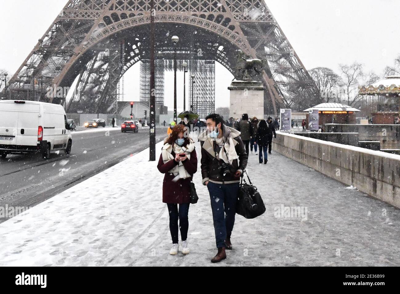 People are seen walking in the streets as snow falls in Paris, France, on  January 16, 2021. Meteo France on Thursday placed 10 departements in the  north and east of the country