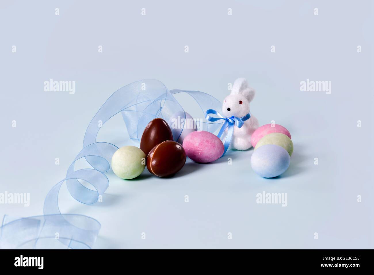 Painted eggs, chocolate eggs and cute bunny figurine Stock Photo