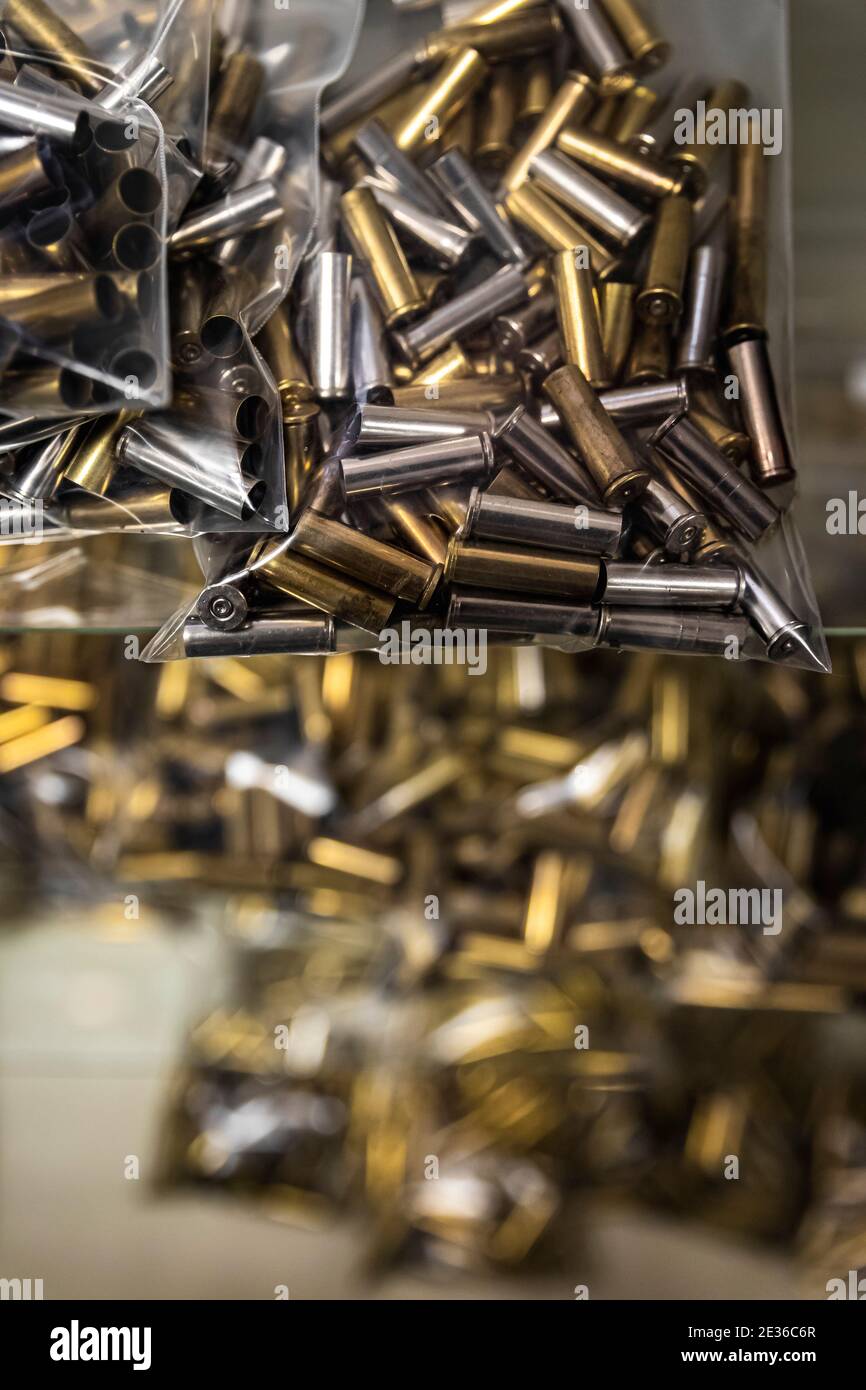 Empty brass pistol cartridges, ammo in bulk on display at a gun shop, ammunition shortage in California Stock Photo