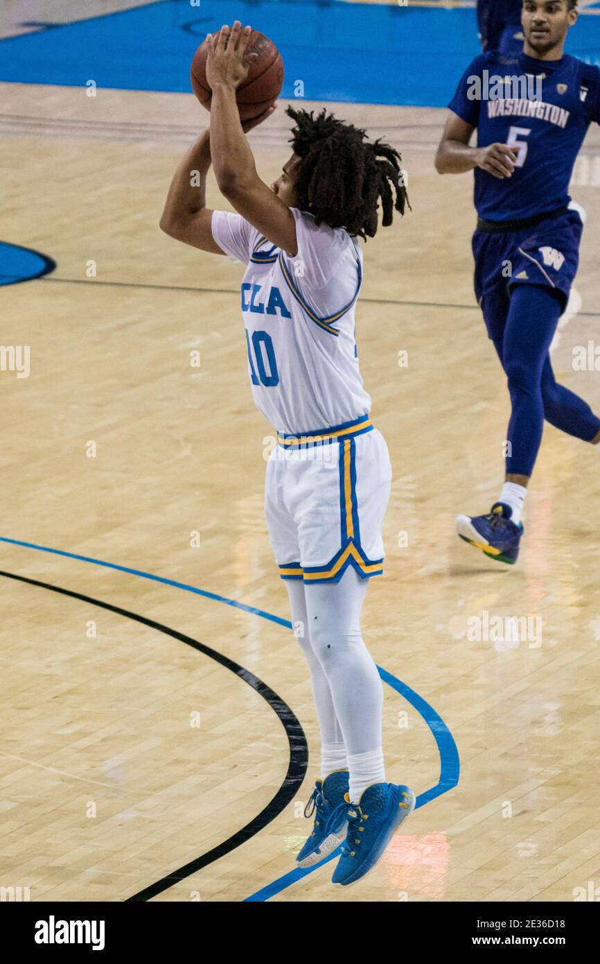 UCLA Bruins guard Tyger Campbell (10) shoots a three pointer during an NCAA college basketball game against the Washington Huskies, Thursday, Jan. 16, Stock Photo