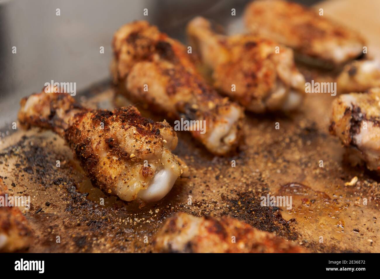Ready to eat roasted spicy chicken wings in glass casserole dish on