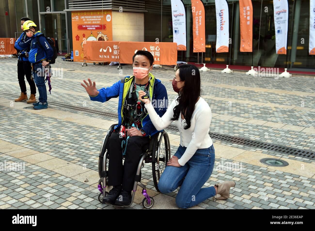 Hong Kong rock climber, sport climber, and motivational speaker Lai Chi Wai, who is paralyzed due to a traffic accident in 2011, left, is interviewed Stock Photo