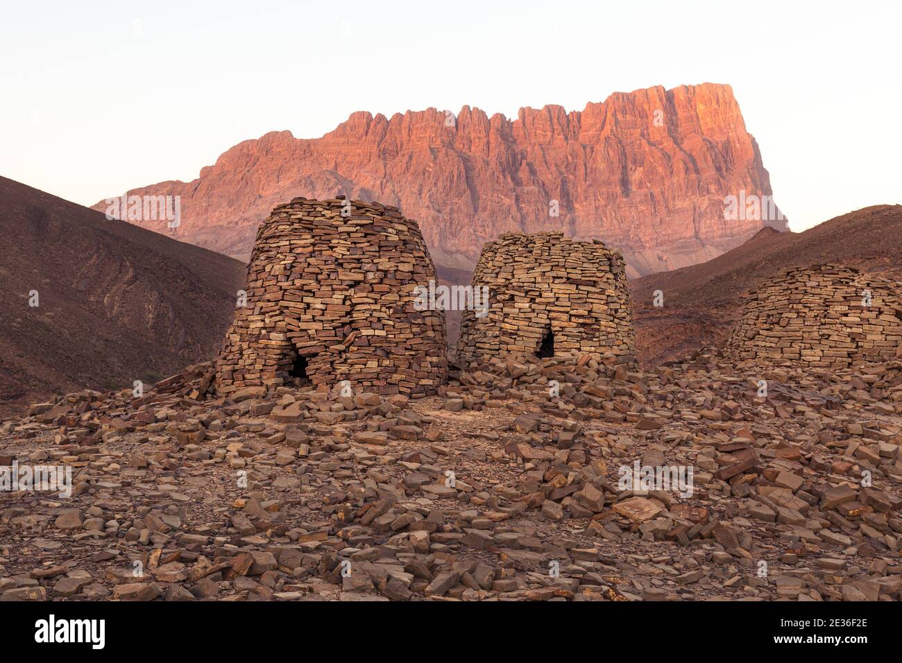 Burial mounds at Al Ayn with Jebel Misht in the background; Oman Stock Photo