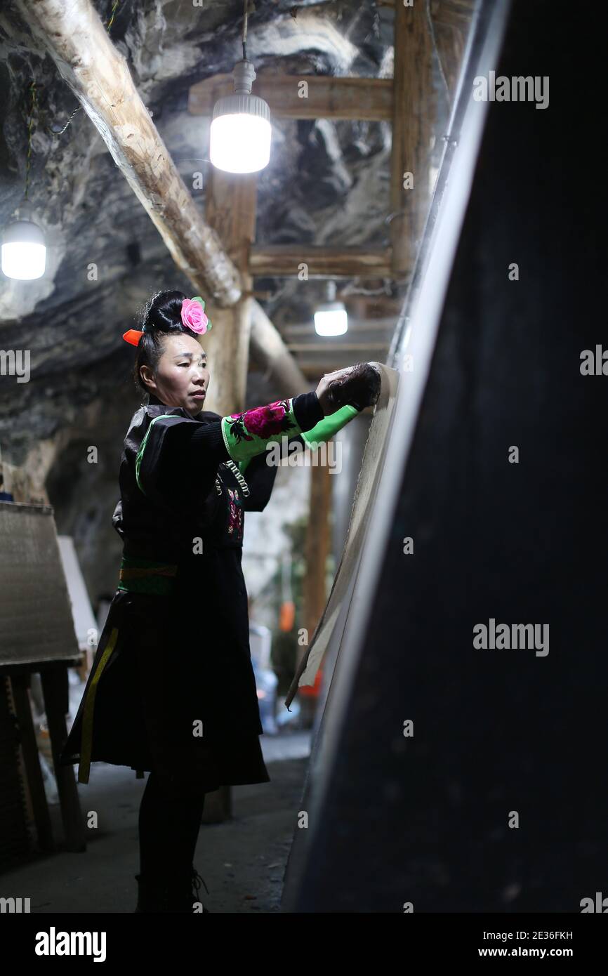 In order to meet demand of customers during the upcoming Spring Festival, Miao villagers are busy making 2,000,000 orders of trditional paper in paper Stock Photo