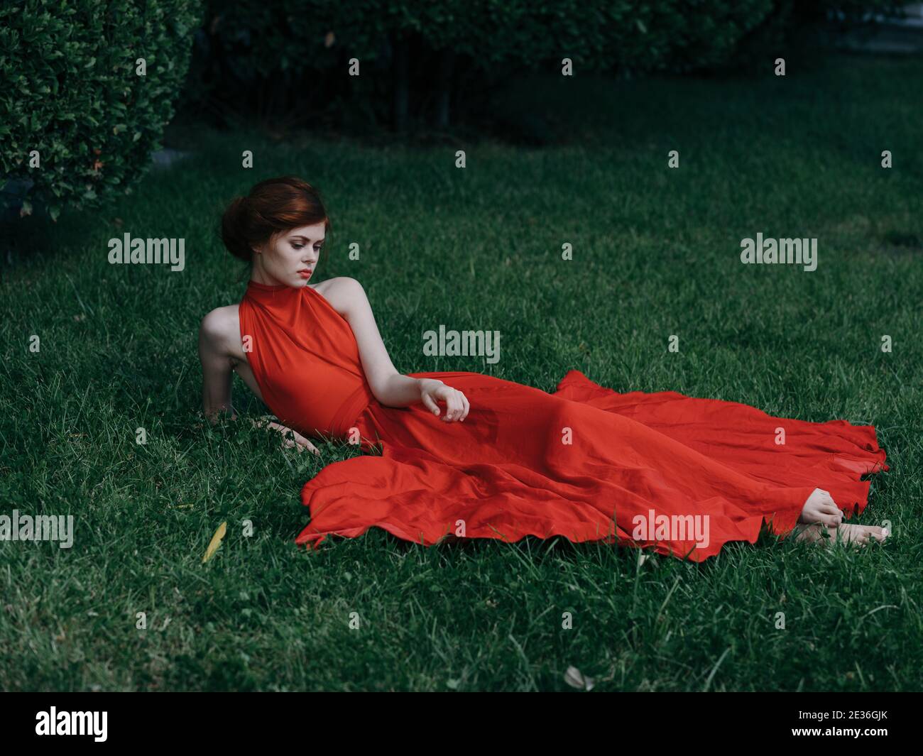 Brunette in red dress lies hi-res stock photography and images - Alamy
