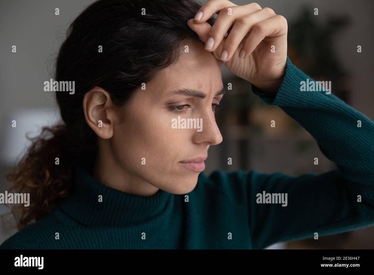 Unhappy young woman look in distance feeling distressed Stock Photo
