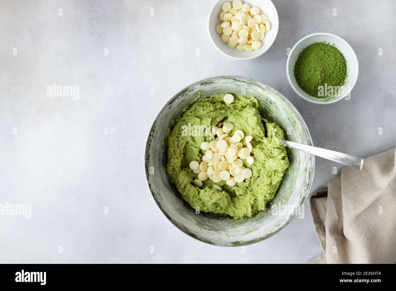 baking background with green tea matcha dough, chocolate chips, eggs Stock Photo