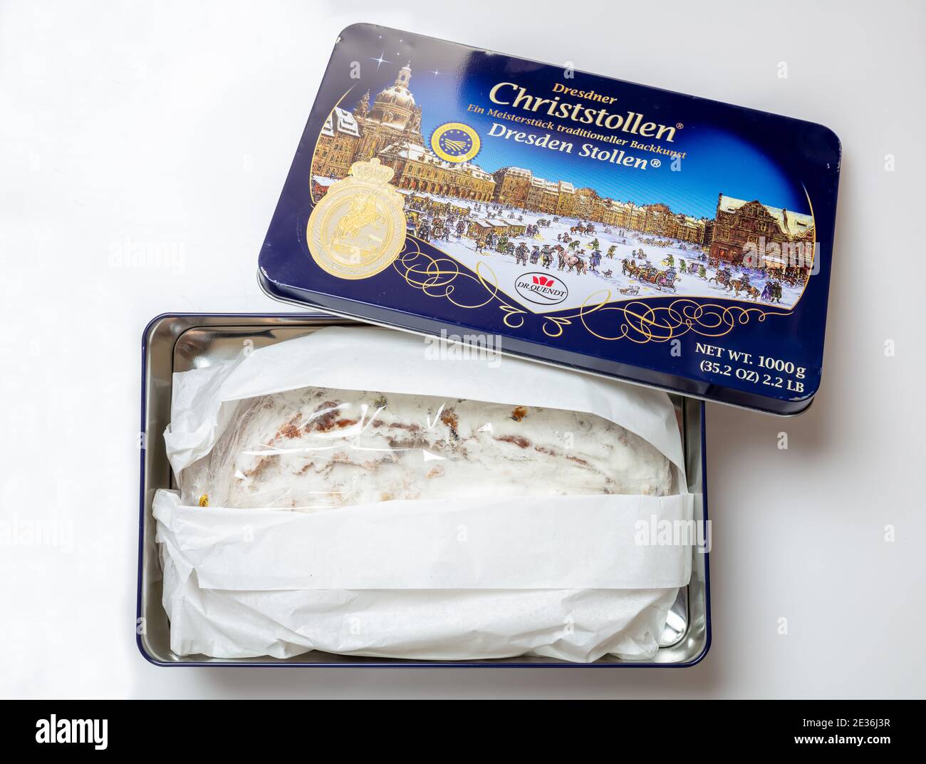 Athens Greece, December 23, 2020. Christmas stollen cake, Dr Quendt Christstollen. Sweet german traditional bread wraped in a metal box, top view. Xma Stock Photo