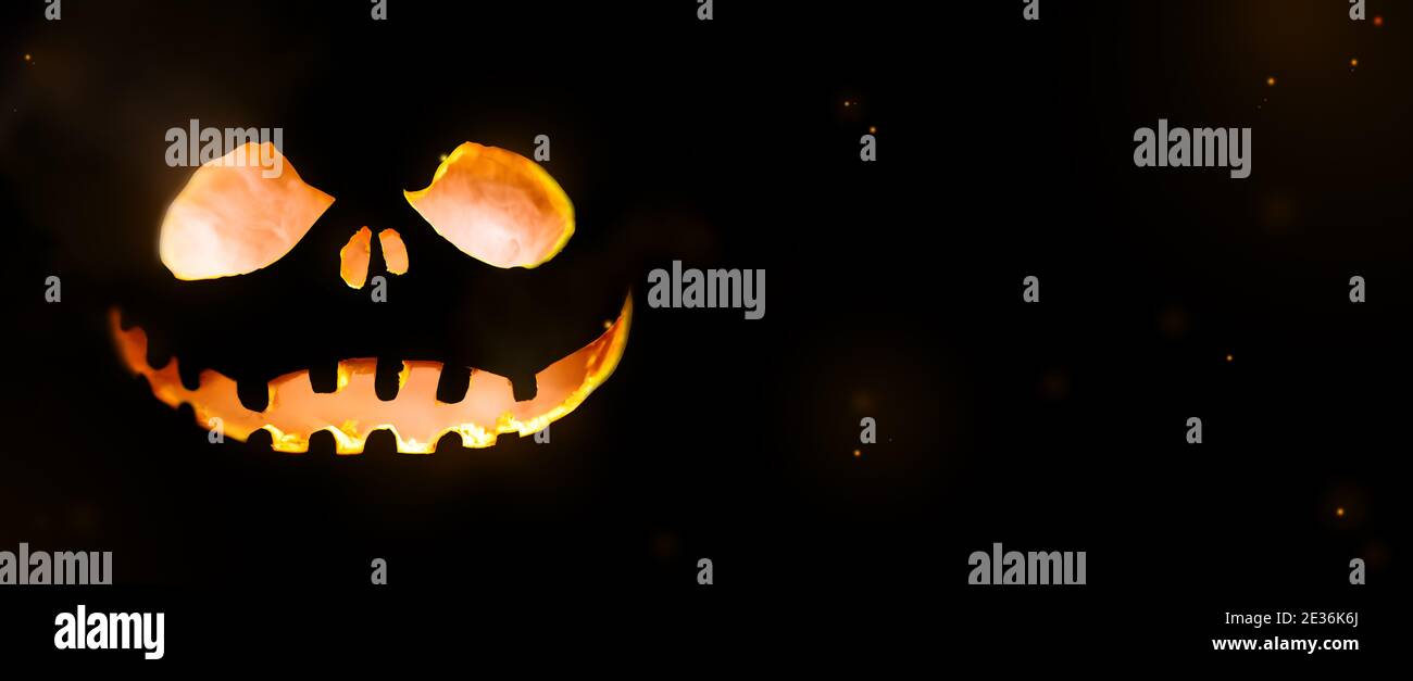 Glowing pumpkin halloween concept in a dark background Stock Photo