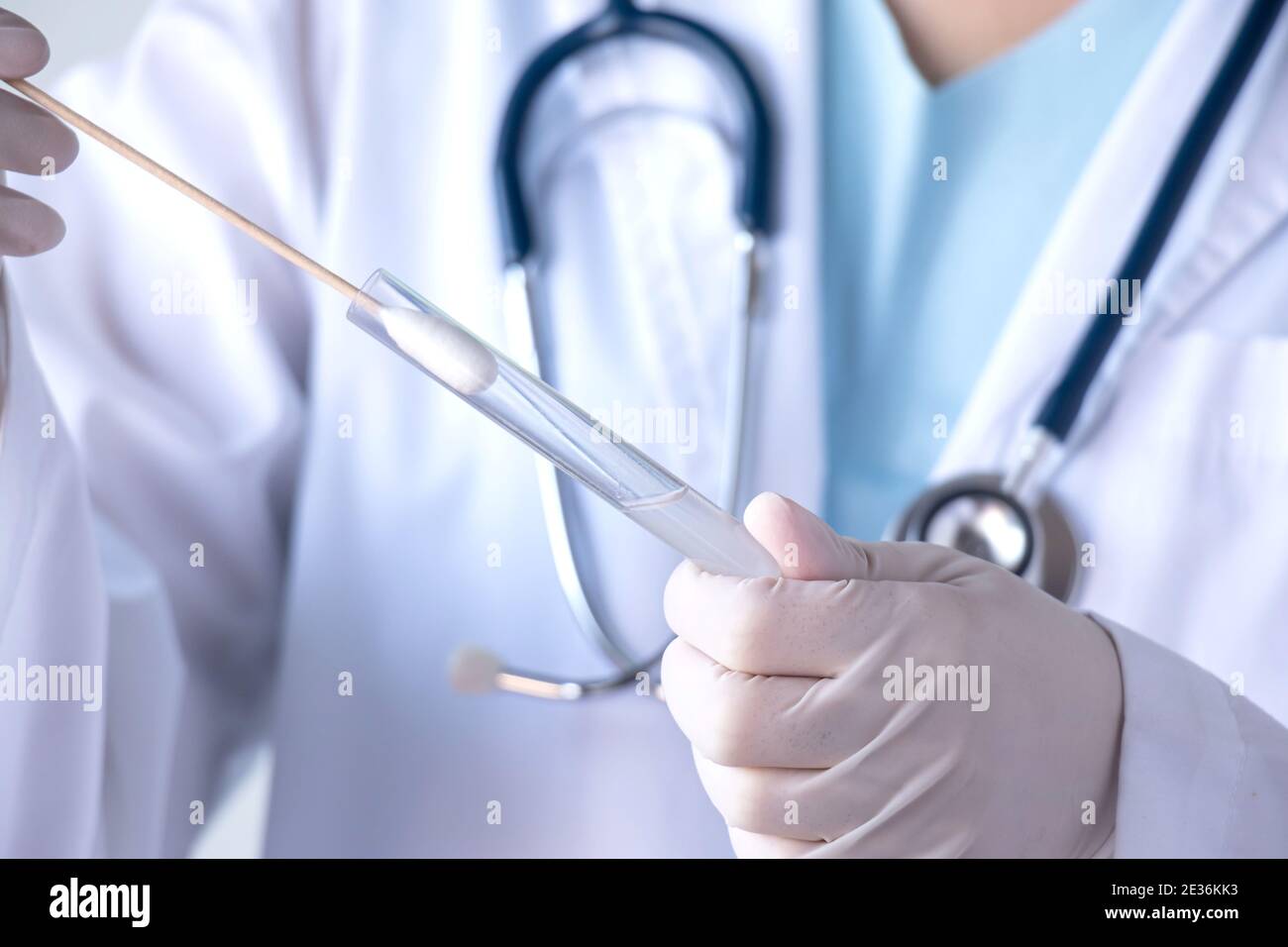 coronavirus COVID-19 test concept. doctor hand with glove holding test tube with patient nasal secretion cotton swab sample for corona virus infection Stock Photo