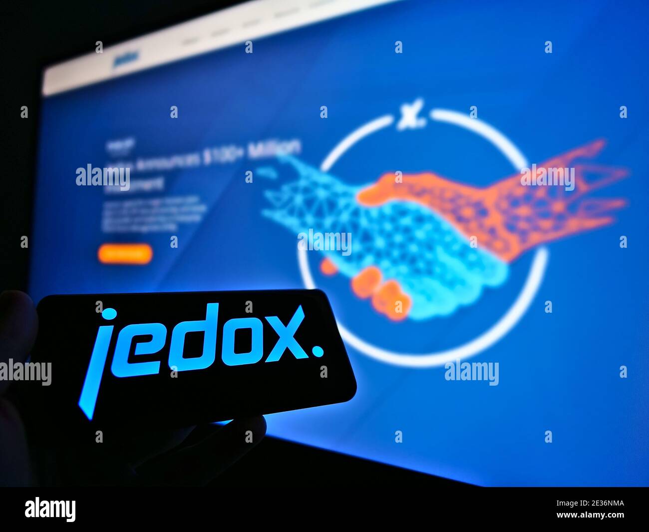 Person holding smartphone with logo of German software development company Jedox AG. Focus on mobile phone screen. Unmodified photo. Stock Photo