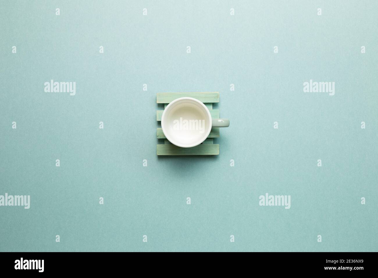 Empty mug cup on mint green background. top view, copy space Stock Photo