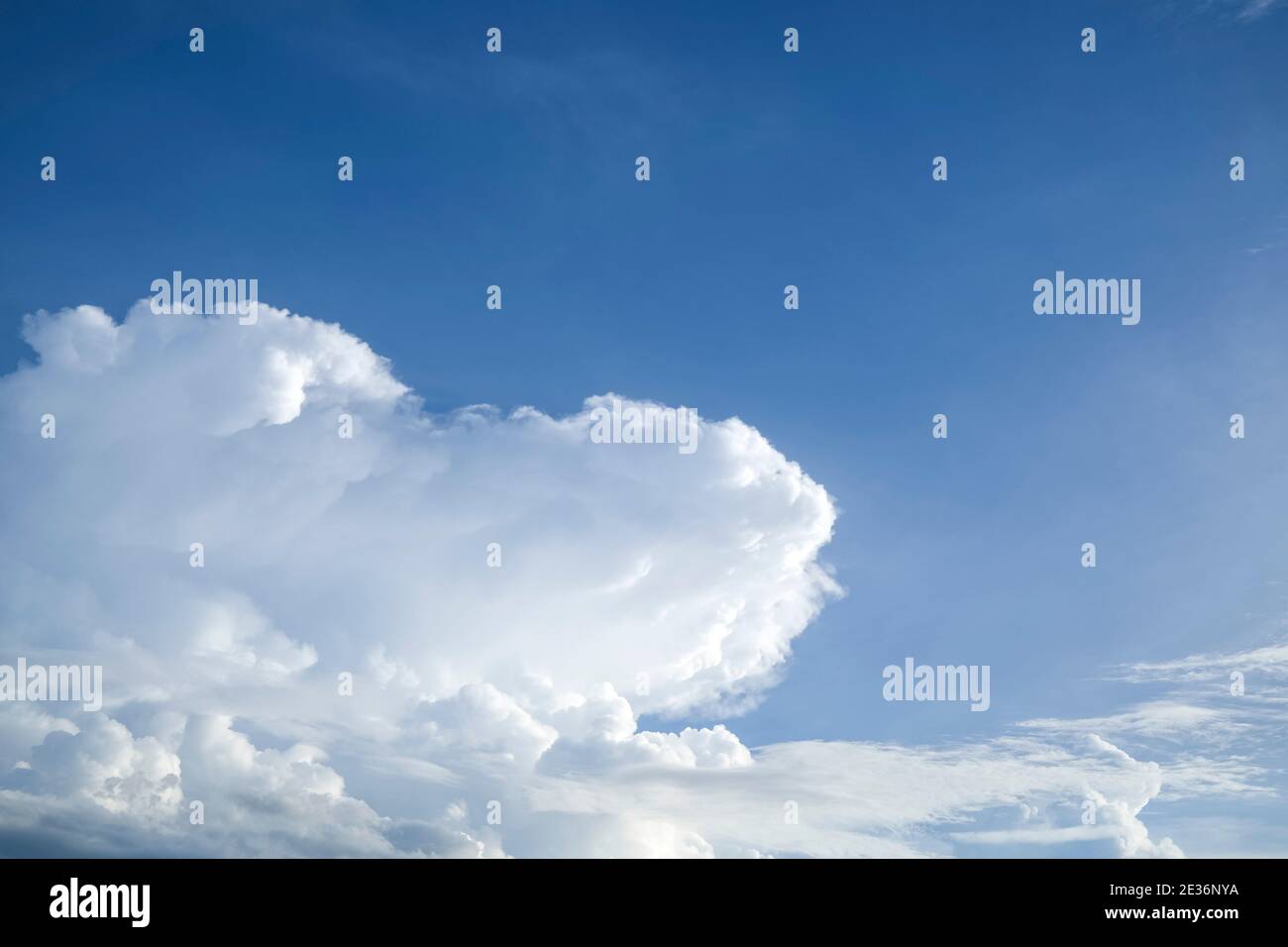 Fluffy white cumulus clouds against blue sky Stock Photo
