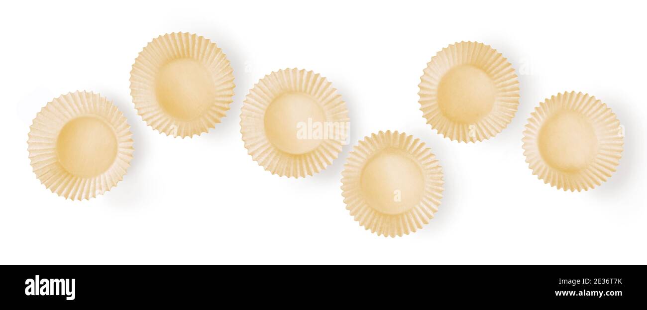Set of paper cupcakes molds against white background. Top view useful for banner Stock Photo