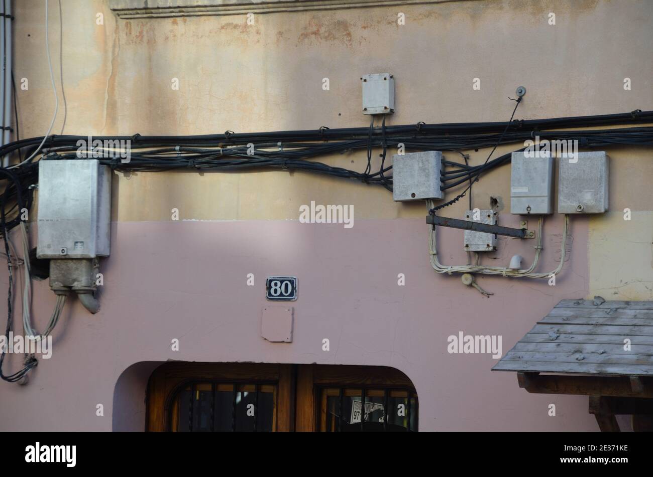 power cables wild relocated to an outside wall in Barcelona Stock Photo