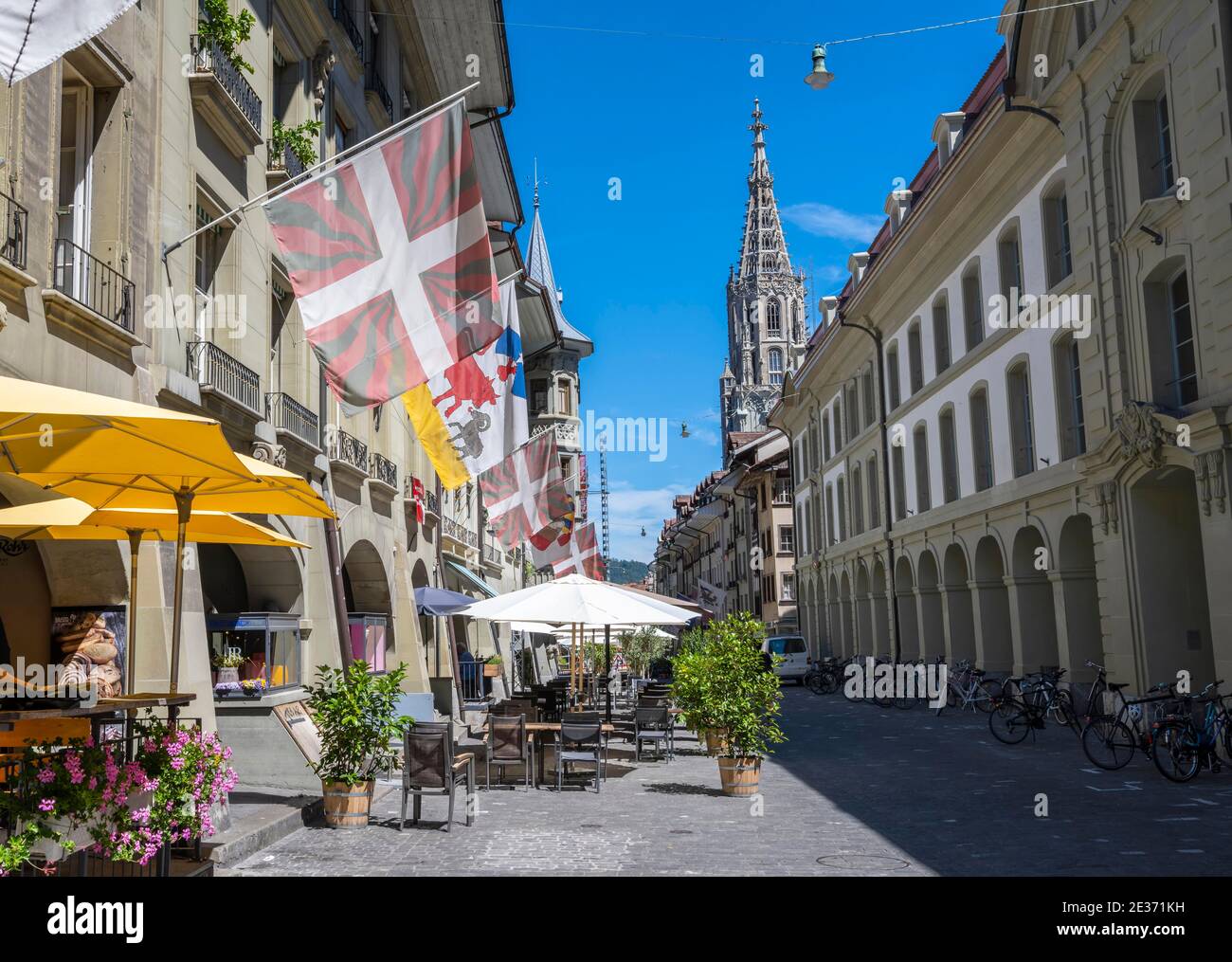 Flags on a row of houses in the old town of Bern, behind tower of the Bern Cathedral, Inner City, Bern, Canton Bern, Switzerland Stock Photo