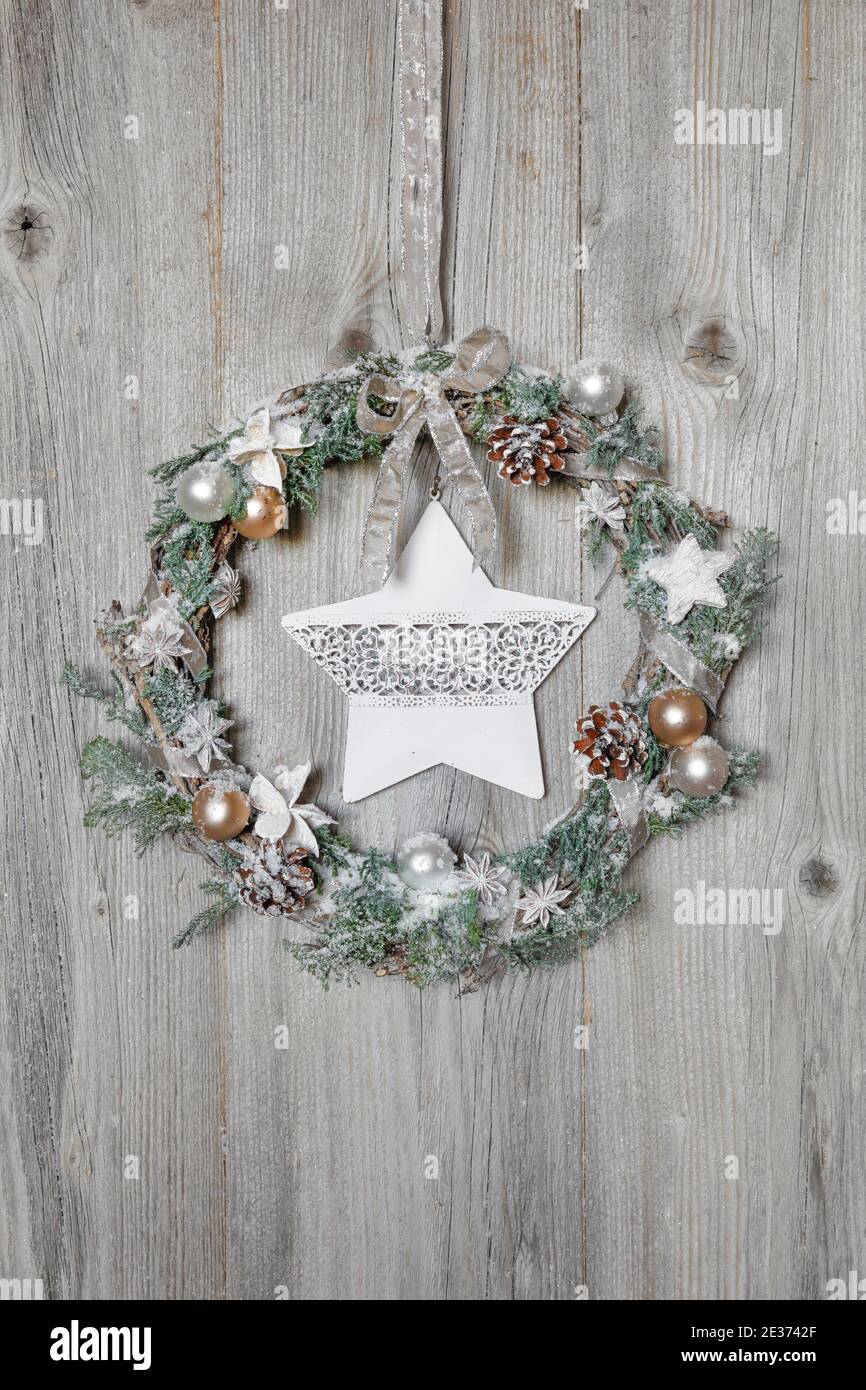 Christmas wreath on wooden wall with star Stock Photo
