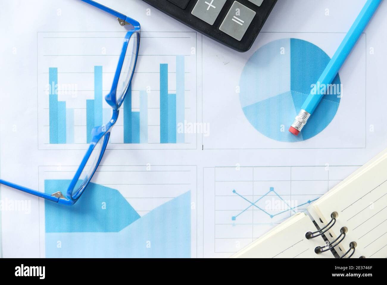 financial graph, calculator and notepad on table  Stock Photo