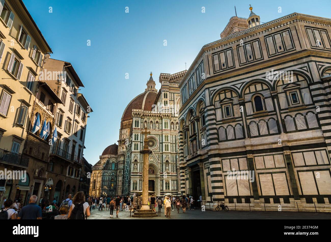 View of Piazza del Duomo in Florence. The square contains the San Zanobi Column next to the Baptistery San Giovanni. Behind is the Santa Maria del... Stock Photo
