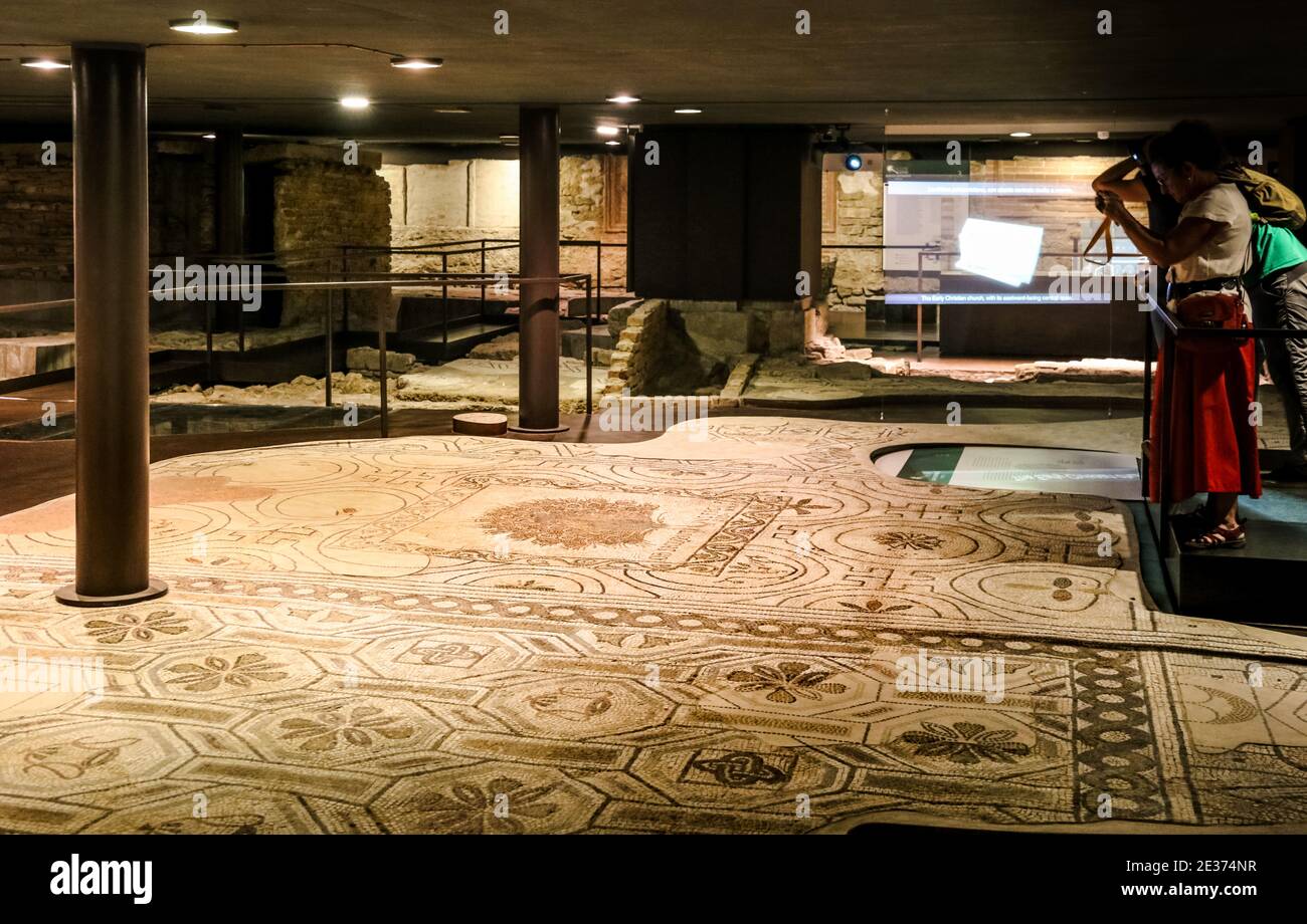 Great view of the Crypt of Santa Reparata beneath the Cathedral of Florence. Visitors admiring the Paleochristian mosaic floor with the beautifully... Stock Photo