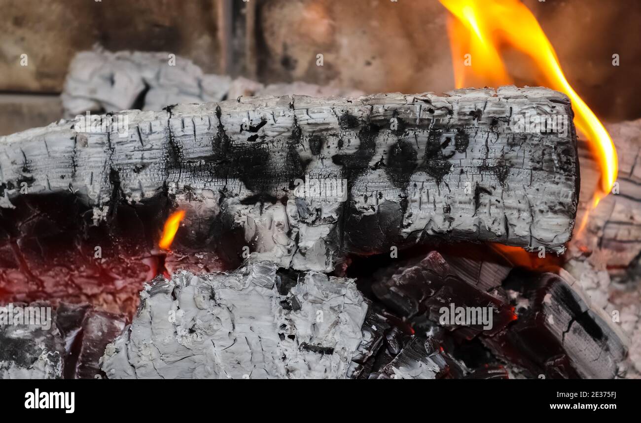A closeup of beautiful red and orange hot burning fire in a fireplace Stock Photo