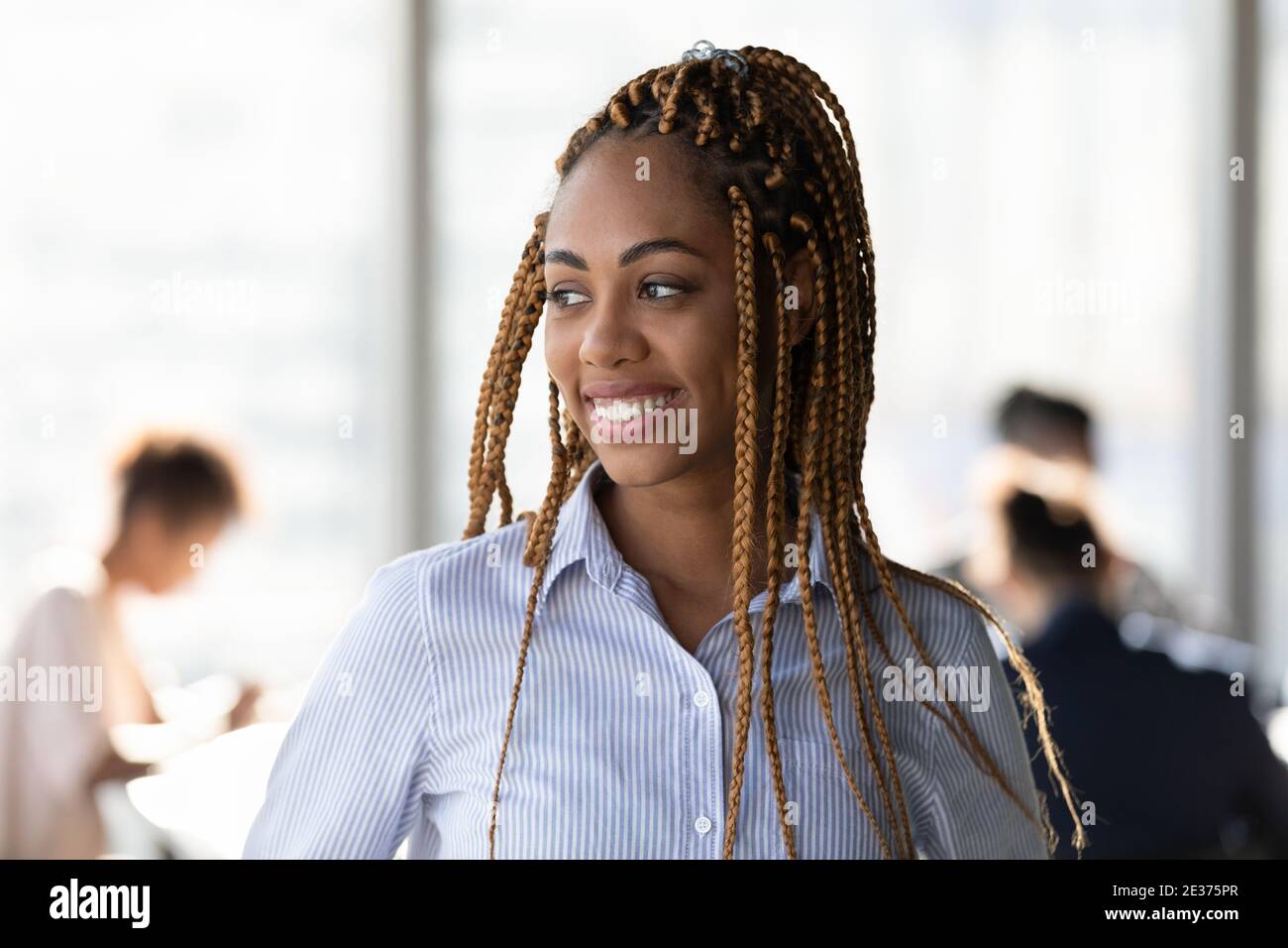 Smiling African American woman look in distance thinking Stock Photo ...