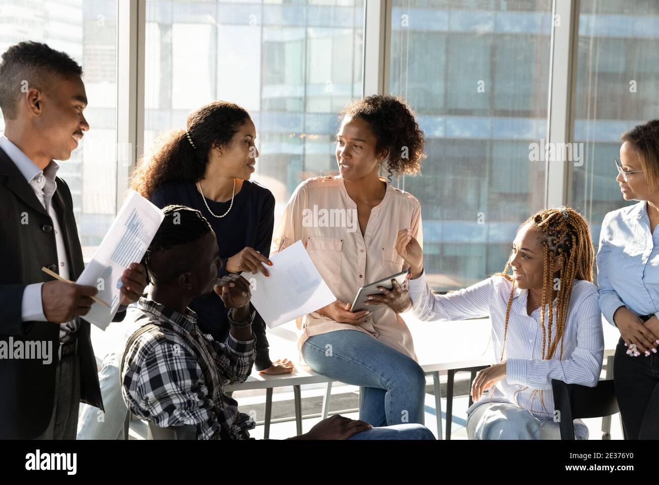 Smiling multiethnic employees brainstorm at meeting in office Stock ...
